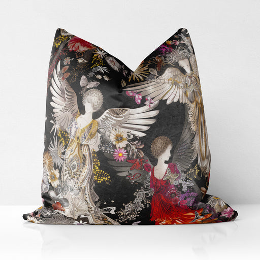 Luxury velvet cushion pillow cover featuring three ethereal figures with wings, adorned in golden, silver, and red flowing gowns, set against a dark background with floral and intricate patterns.