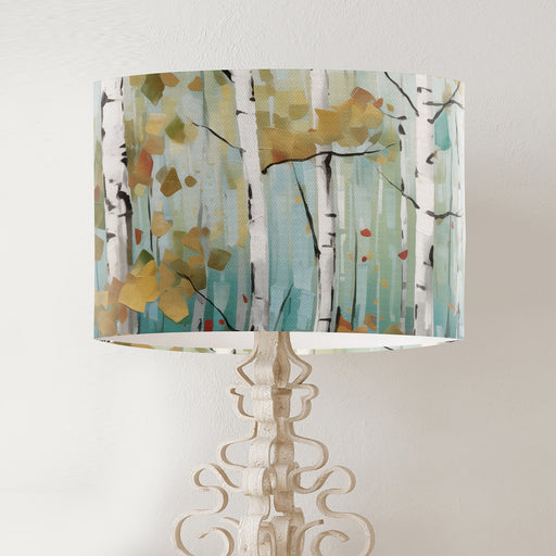 Scandi birch tree scene on a muted dusty jade background on a classic sized 30x21cm handcrafted fabric lampshade by artist Kelly Stevens-McLaughlan