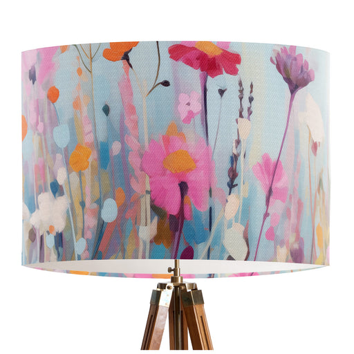 Delicate colourful wildflower design against a serene pale blue backdrop on a classic sized 30x21cm handcrafted fabric lampshade by artist Kelly Stevens-McLaughlan