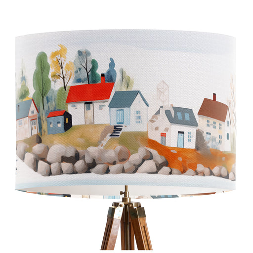A vibrant whimsical Scandinavian coastal village design on a classic sized 30x21cm handcrafted fabric lampshade by artist Kelly Stevens-McLaughlan