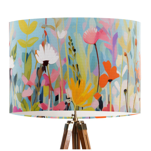 Vinrentia colourful wildflower design against a sky blue backdrop on a classic sized 30x21cm handcrafted fabric lampshade by artist Kelly Stevens-McLaughlan