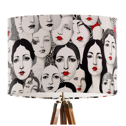 Monochrome womens faces with red lipstick cover this design on a classic sized 30x21cm handcrafted fabric lampshade by artist Kelly Stevens-McLaughlan